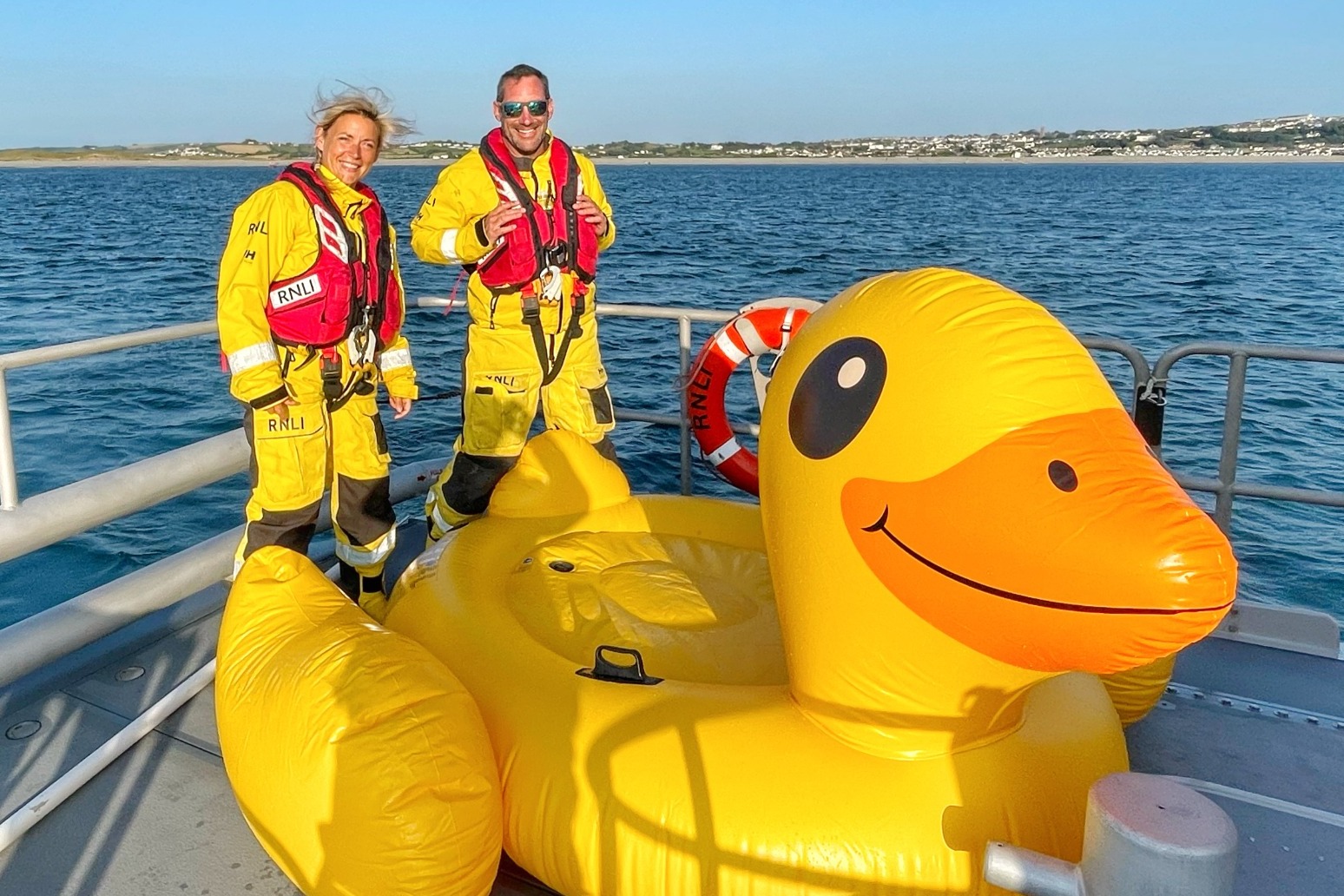 Three people rescued after giant inflatable duck drifts out to sea 