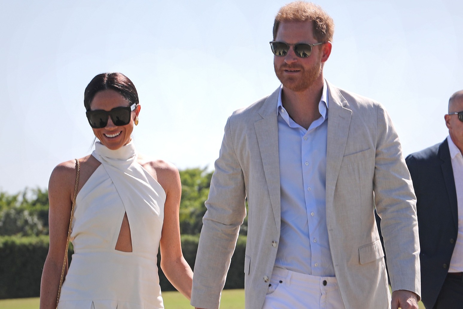 Harry and Meghan hand in hand at charity polo match 