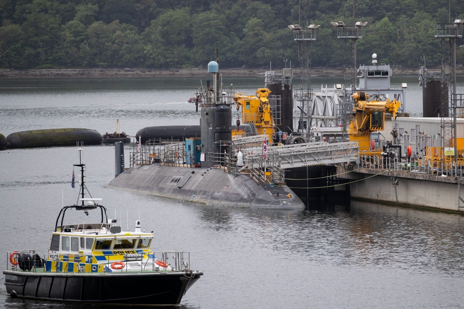 Iranian man and Romanian woman charged after submarine base incident