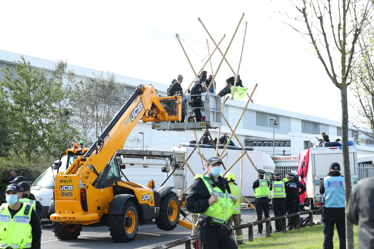 Police charge 26 people following protest outside printing works 