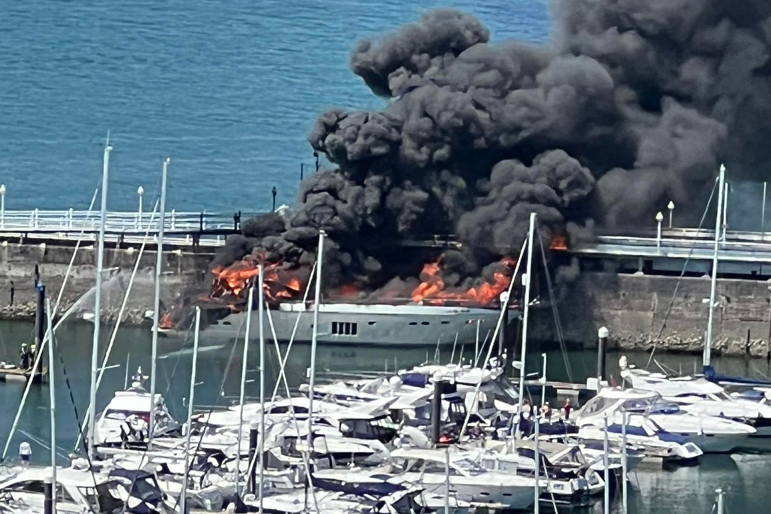 Major clean-up in marina after fire on superyacht carrying tonnes of fuel 