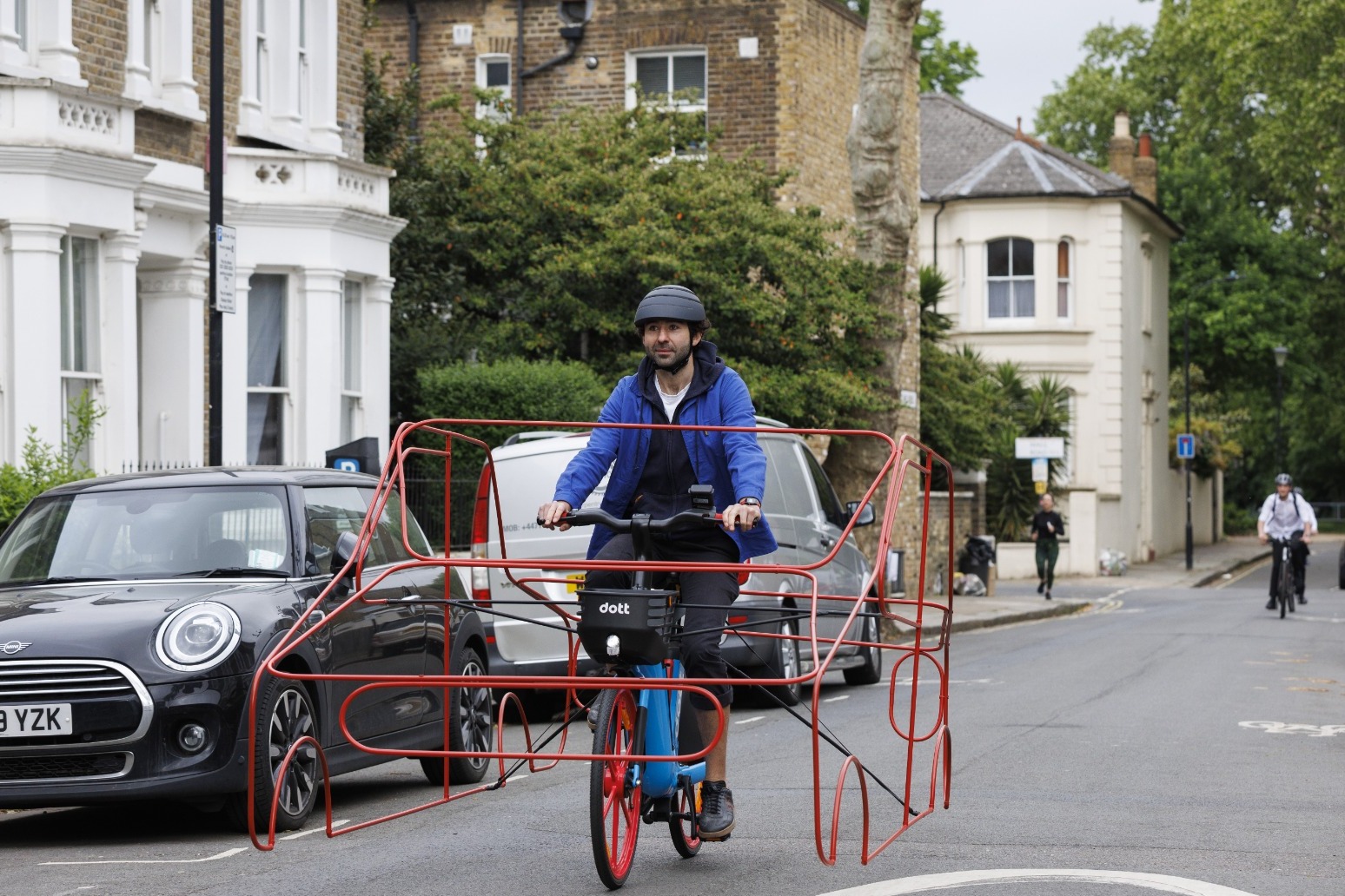 Cyclists wear car frames to show ‘absurdity’ of vehicles hogging roads 