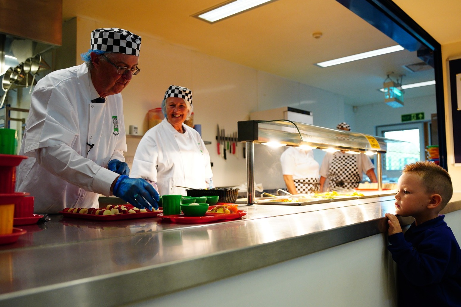 Mark Drakeford serves free school meals to primary school children 