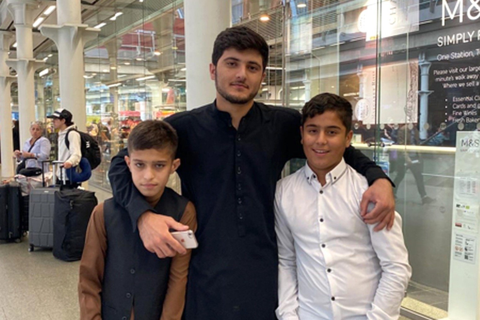Afghan boy, 11, reunited with twin brother in UK after a year stranded in France 