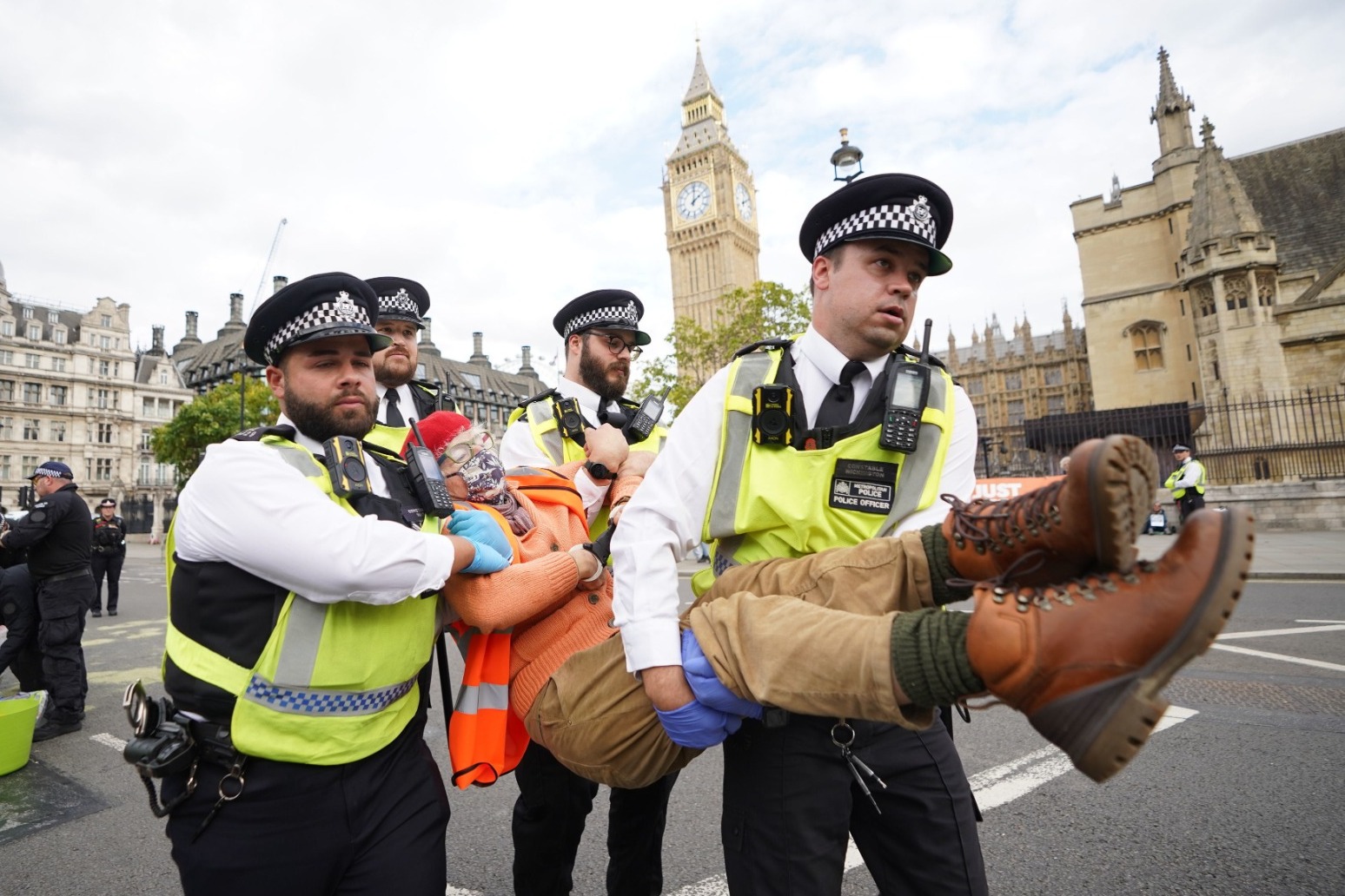 Police arrest activists who glued themselves to road outside Parliament 