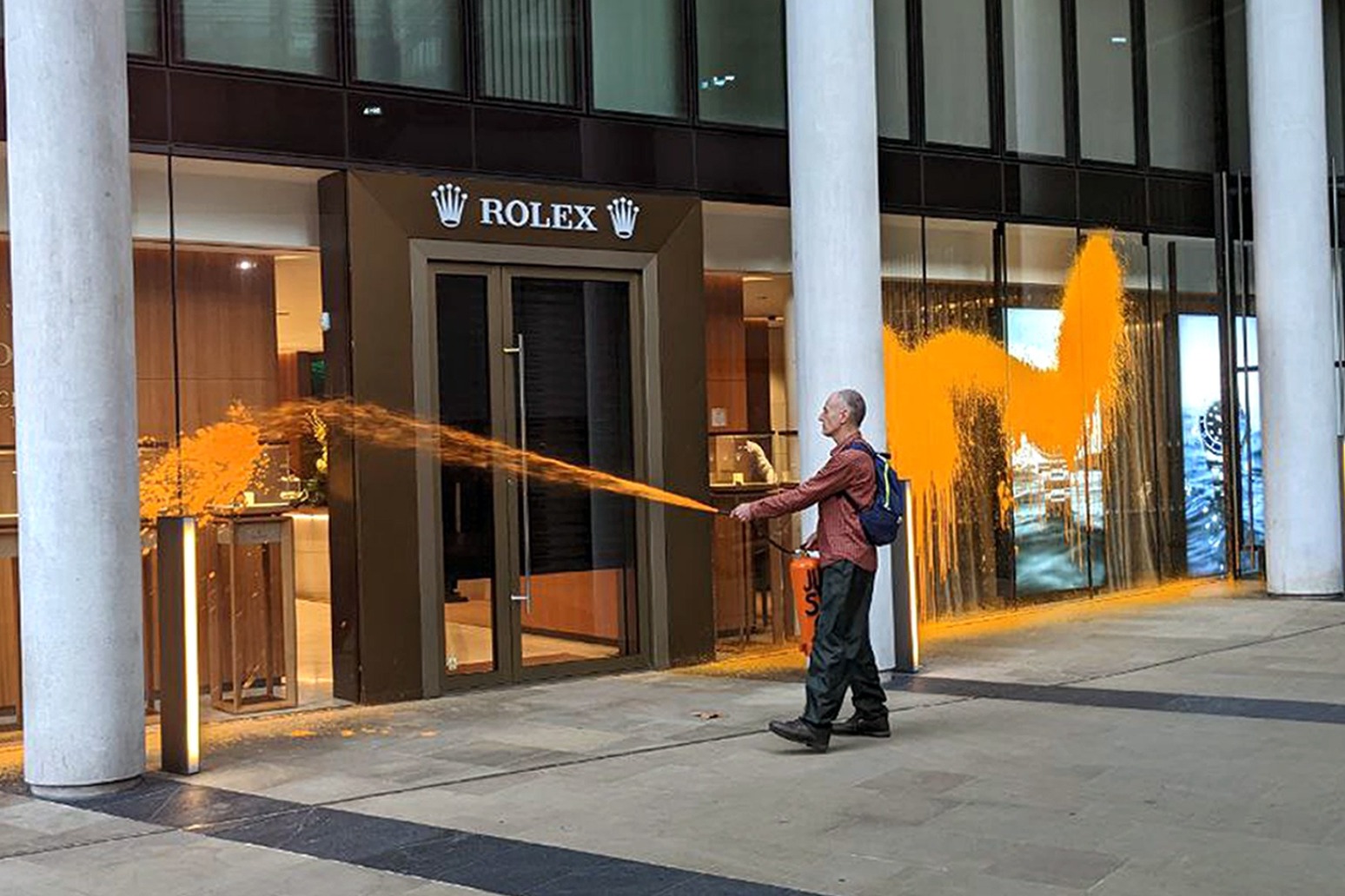 Just Stop Oil activists spray orange paint on Rolex building in central London 